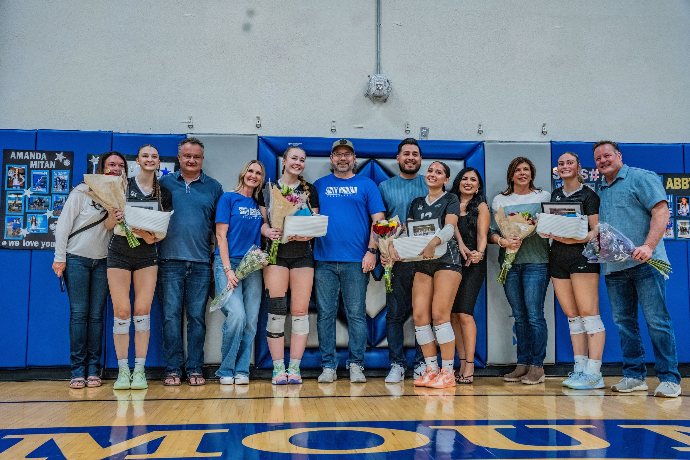 The four sophomores pose with their families before the match. 